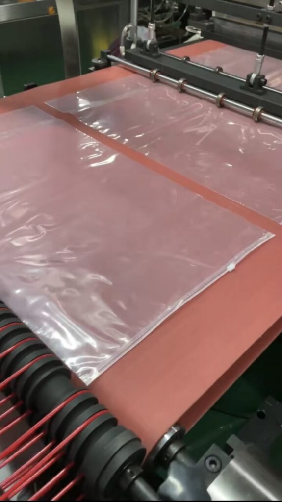red silicone conveyor belt operating on a zipper bag-making machine